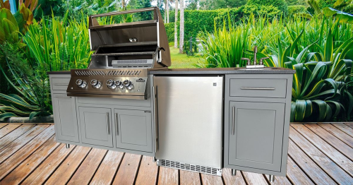 Outdoor kitchen with grill and refrigerator on a wooden deck