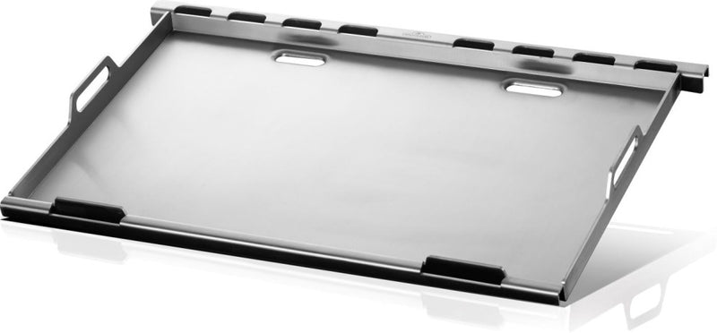Metallic tray with black handles on a reflective surface