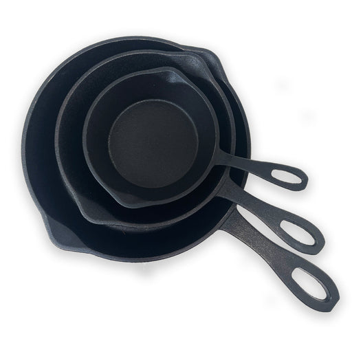 Set of three black cast iron skillets with measurements on a white background