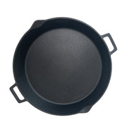 Black cast iron skillet on a white background