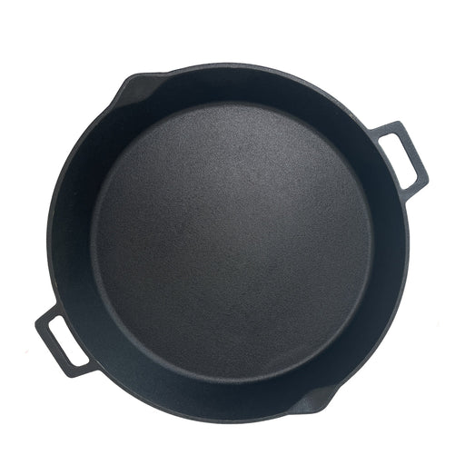 Black cast iron skillet on a white background