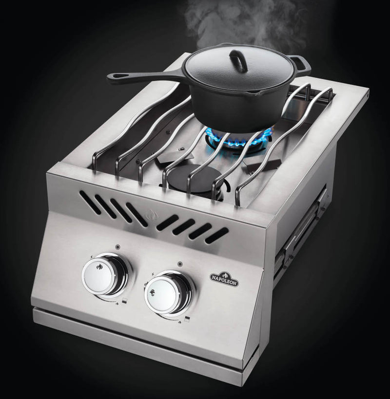 Portable gas stove with a pot on a black background