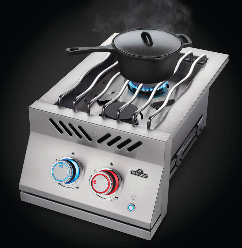 Portable gas stove with a pot on a black background
