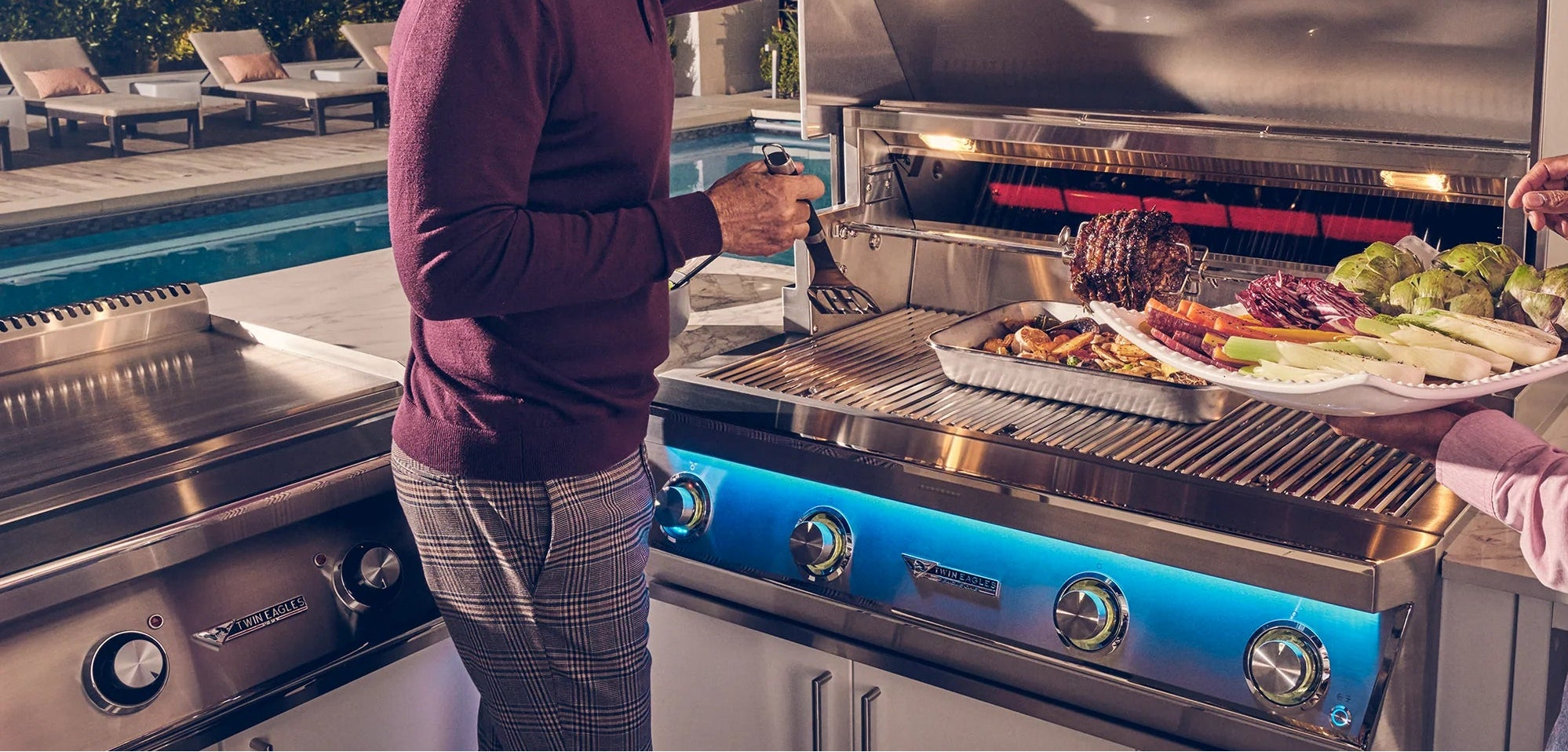 gentleman holding a food tray and opening a grill to cook food