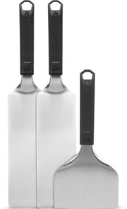 Three metal spatulas with black handles on a white background