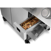 Smoker with wood chips in the drawer on a white background