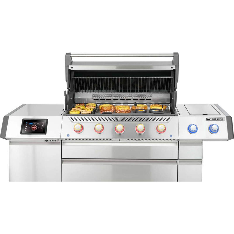 Stainless steel grill with digital display and control knobs on a white background