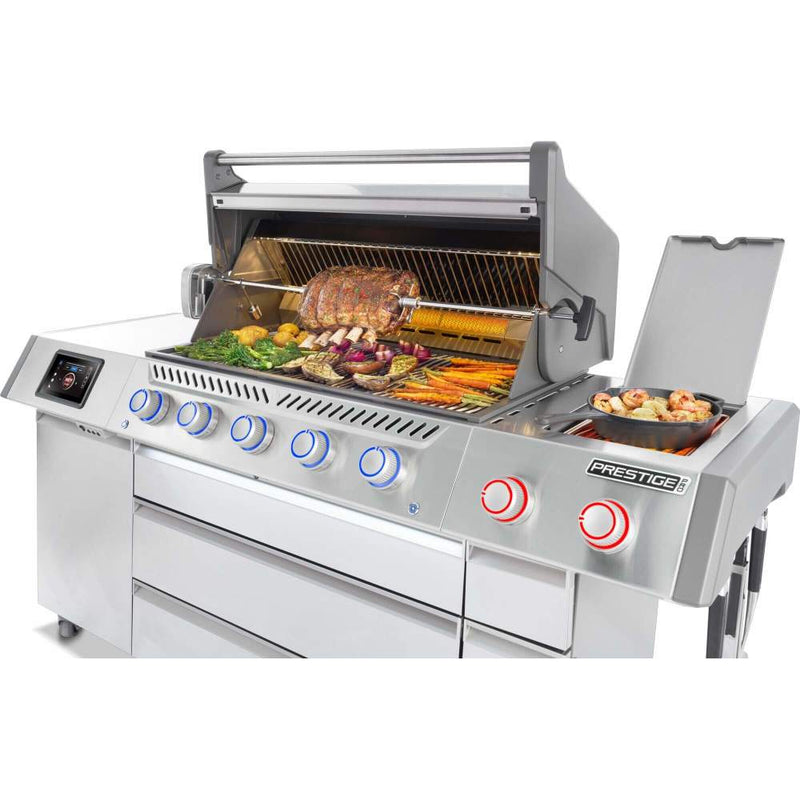 Stainless steel grill with food being cooked on a white background
