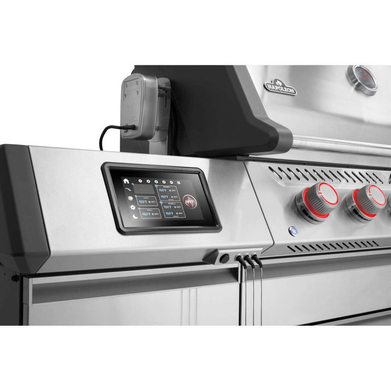 Stainless steel grill with digital control panel and red knobs on a white background