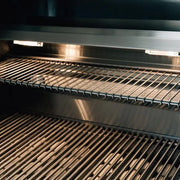 Close-up of a grill with metal grates inside an oven.
