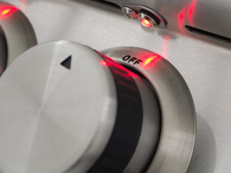 Close-up of a metallic control knob with 'OFF' label and red indicator light.