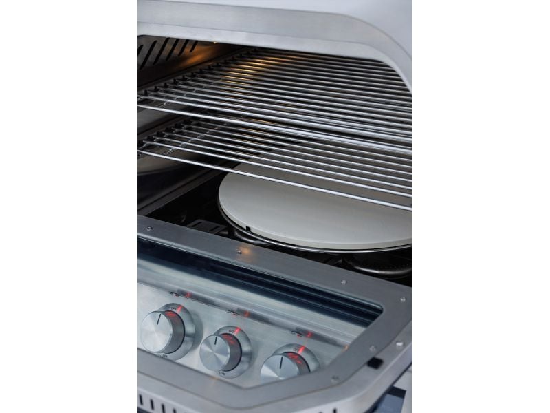 Stainless steel oven with racks and a white plate inside
