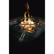 Stainless steel gas stove with flames burning on a black background